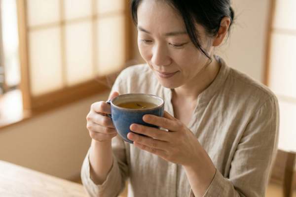 Japanese woman drinking a cup of herbal tea
